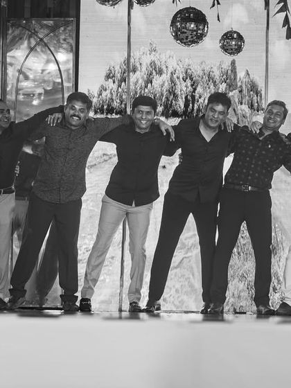 A fun black and white shot of the groom's friends striking a pose. This captures the "Yeh Dosti Hum Nahi Todenge" vibe perfectly.