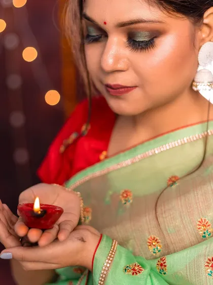 A close up shot demonstrating how to use a simple prop like a diya as a key light source. This is a practical lighting technique we cover to help students create evocative and professional looking images.