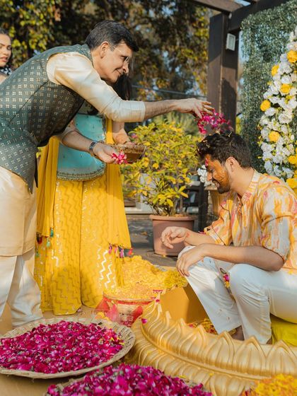 A father blesses his son during the Haldi ceremony. We capture these significant moments of parental love and pride.
