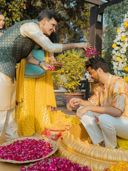 A father blesses his son during the Haldi ceremony. We capture these significant moments of parental love and pride.