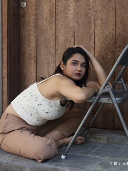 This creative portrait uses a chair as a prop to create interesting lines and a dynamic, low-angle composition.