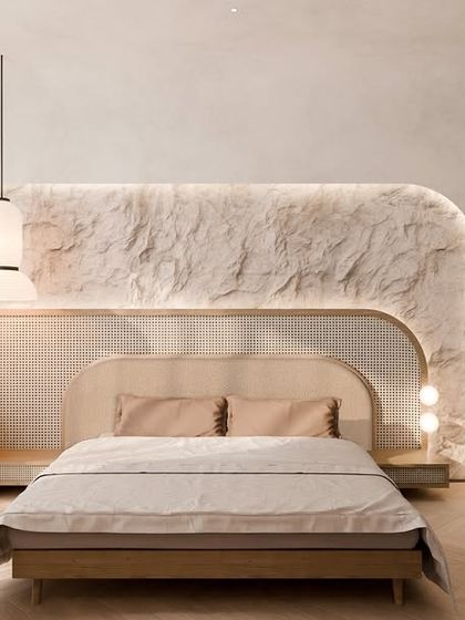 A wider view of the serene bedroom, showing the balance of textures from the raw stone wall to the woven cane on the wardrobe and nightstand. The design is grounded in earthy tactility and quiet luxury.