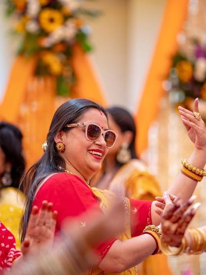 The joy of family is palpable as guests dance and celebrate at the Haldi function.