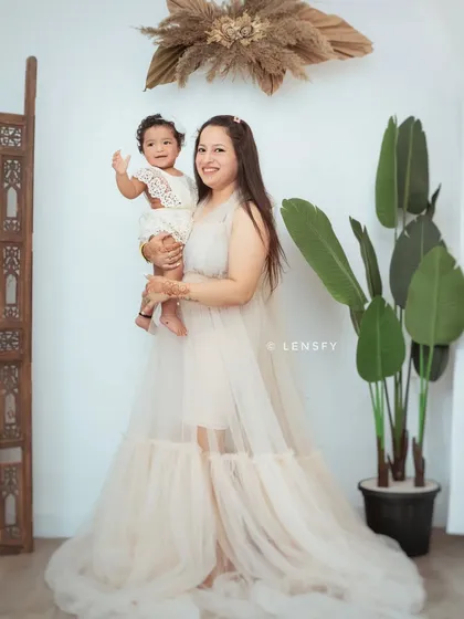 A beautiful mother and daughter portrait in our boho studio setup. We provide elegant gowns for mothers to create these stunning images.