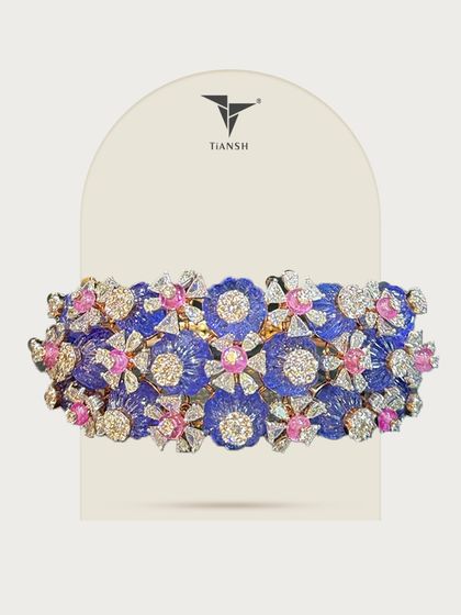 Each bloom in this cuff tells a story. I used carved petals, diamond dew, and pops of pink sapphire to create a masterpiece of color and craft.