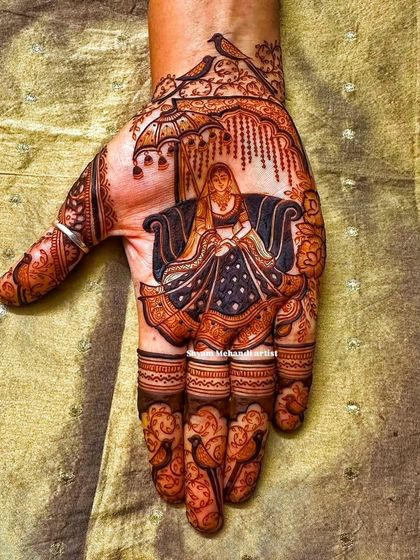 Another angle of the bride in a doli, showing the delicate details of the umbrella and the birds.