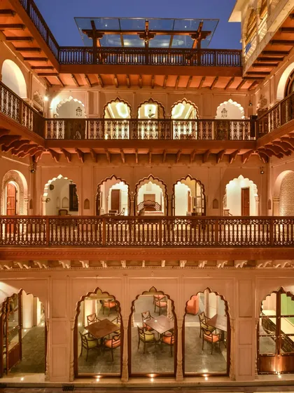 The view of Haveli Dharampura's courtyard at dusk, illuminated to highlight its multi-level design. This project, which took six years to complete, was honored with the UNESCO Asia-Pacific Award for Cultural Heritage.