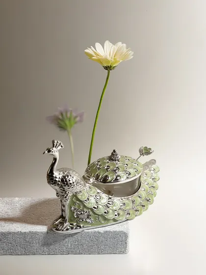 Our peacock-shaped dry fruit box, shown here in a soft mint green enamel. This piece is a whimsical yet elegant blend of form and function, perfect for adding a pop of color to your serveware collection.