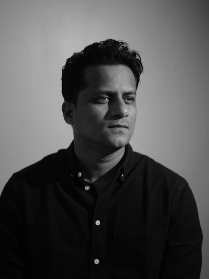 A monochrome version of the portrait, emphasizing the strong shape and clean lines of the haircut.