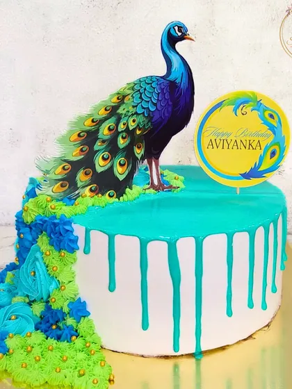 This peacock cake is a perfect example of my passion for detailed artistry. I used careful piping and a vibrant color palette to create the peacock's flowing train, all with fresh cream, making it a stunning and delicious centerpiece for a special birthday.
