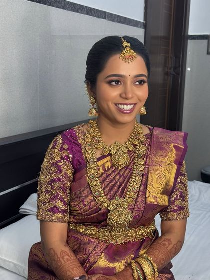 Another joyful shot of Anitha, capturing her excitement on her wedding day. The HD makeup ensures she looks perfect from every angle, with a smooth finish that lasts throughout the long ceremony.