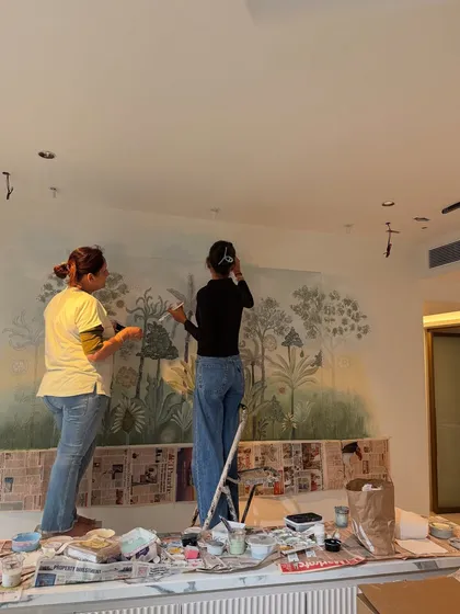 Two artists at work. This photo captures my mother and another artist adding the finishing touches to the 3D mural. It highlights the collaborative spirit and the immense effort that goes into our custom art pieces.