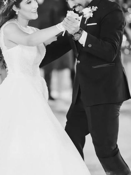 A classic black and white shot of the couple mid-dance. This captures the elegance and romance of the first dance as a married couple.