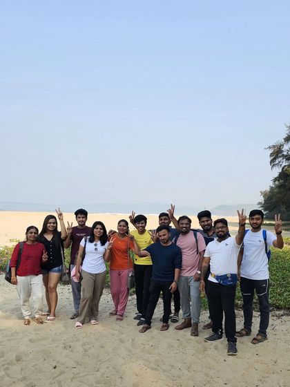 A victory pose from our group on a sandy beach in Gokarna.