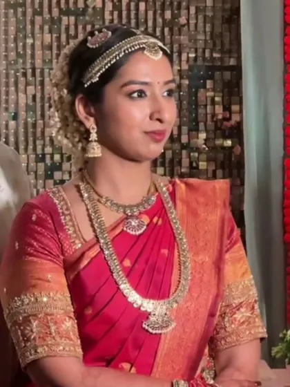 A close-up of the bride's beautiful and serene look in her red Madisar saree.