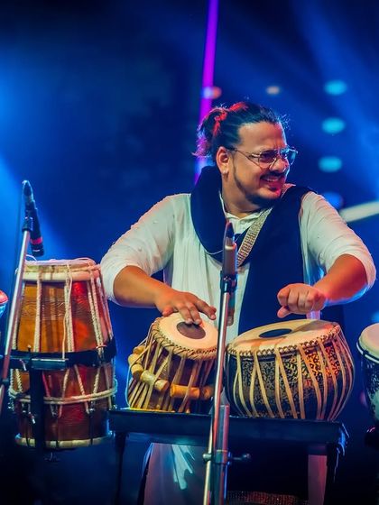 Our percussionist, smiling as he creates the intricate rhythms that define our sound.