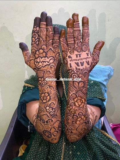 This design features the name 'Nazia' in Arabic script and the initials 'N' and 'N'.