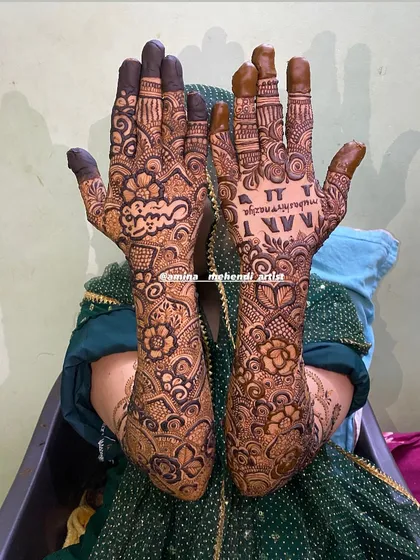 This design features the name 'Nazia' in Arabic script and the initials 'N' and 'N'.