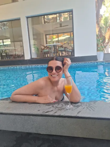 "Currently Accepting Compliments Only." A happy moment enjoying a mimosa in the pool in Goa. This is all about capturing the vacation state of mind.