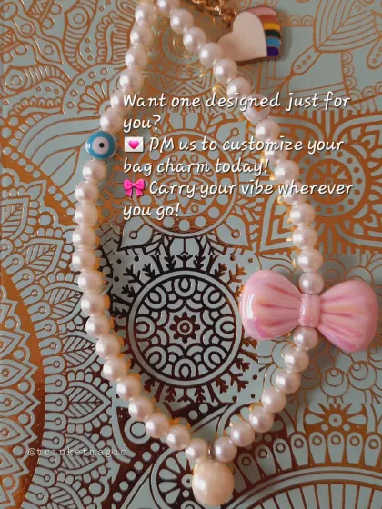 Carry your vibe wherever you go. This custom pearl bag charm, with its pink bow and evil eye bead, looks stunning against a patterned background, showing how it can be a statement piece.