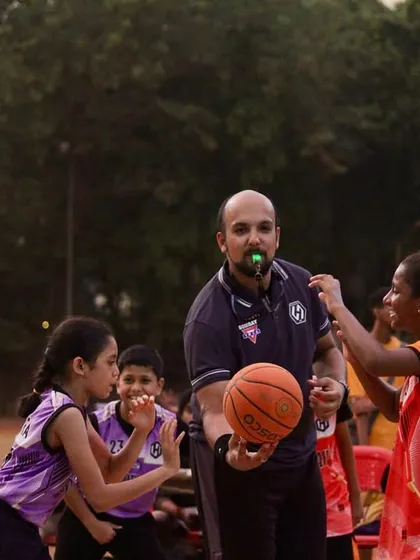 A referee gets the game started with a jump ball in the U-11 division. It's amazing to see the competitive spirit in our youngest players.
