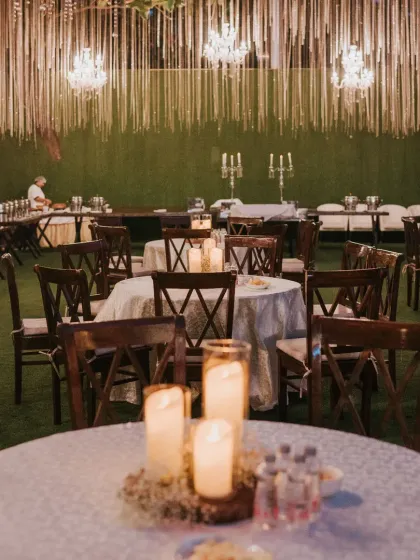 The ambiance of this outdoor reception was pure magic. We used a canopy of string lights, crystal chandeliers, and candlelit centerpieces on each table to create a warm, intimate, and incredibly romantic dining experience for the guests.