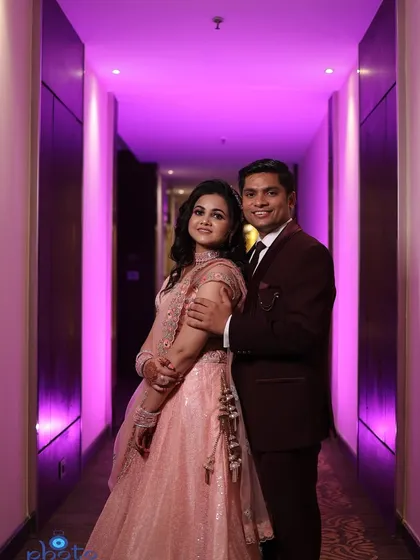 A stylish couple portrait taken in a hotel corridor with vibrant purple uplighting. This is a great example of how I use the venue's environment to create modern engagement photos.
