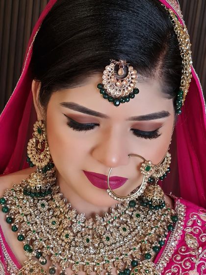 The artistry of the makeup and the jewelry. The brown smokey eye complements the heavy jewelry and the bold lip color.