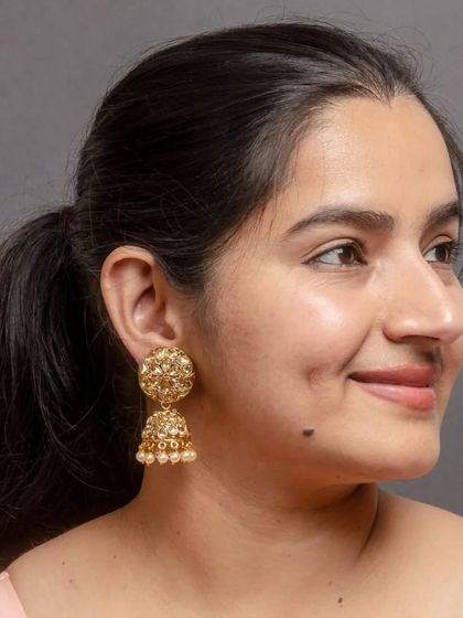 We love to enrich your jhumki collection. These golden jhumkas are made with a copper base and LCT stones, offering a classic look that is both lightweight and perfect for the wedding season.