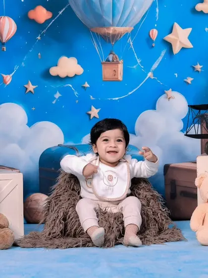 A joyful one-year-old celebrating her birthday surrounded by her teddy bear friends.