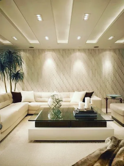 An example of a relaxing living room centered around a large, comfortable L-shaped sofa. I believe in using deep cushions and soft textures to create a truly cozy and unwinding atmosphere.