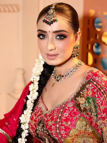 A close-up portrait of this stunning bridal look. The makeup is classic and clean, with defined eyes and a soft nude lip.
