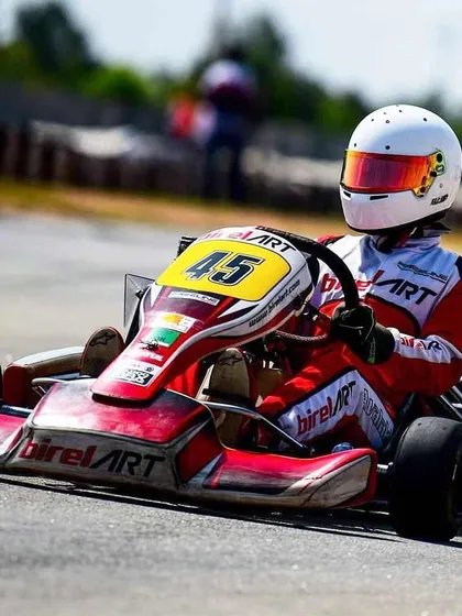 A clear view of the Birel ART kart number 45 on a sunny race day, ready for high-level competition.