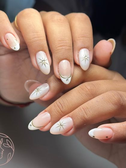 Another view of the elegant and celestial-themed nail art with starbursts and chrome accents.