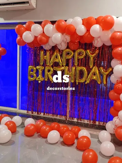A wider angle of the red and white balloon arch, showing how it frames the party space in a home.