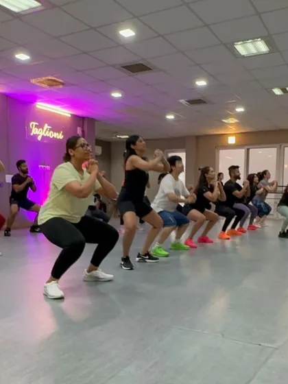 It's not just about cardio. We incorporate strength and conditioning moves into our routines to build muscle and endurance. Here you can see the whole class powering through a set of squats together.