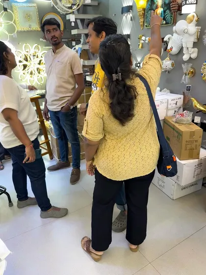 A group discussion during a lighting selection visit. The whole family gets involved in choosing the fixtures for their new home.