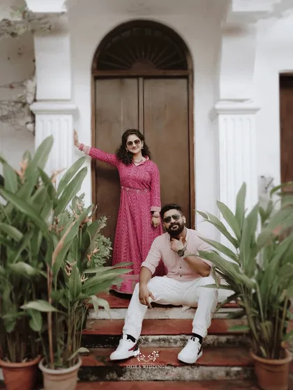 A stylish shot of the couple posing on steps, exuding a cool and confident vibe.
