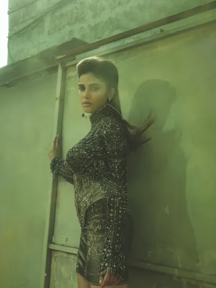 Another angle from the metallic slay shoot. The lighting catches the sharp, defined makeup and the structured hairstyle.