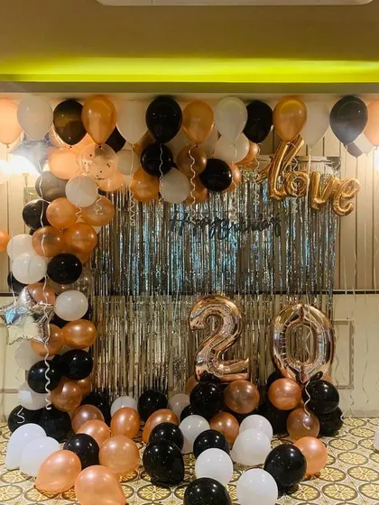 A clear, straight-on shot of the 20th birthday party decoration. This view shows the symmetry of the balloon arch and the placement of the '20' and 'Love' foil balloons.