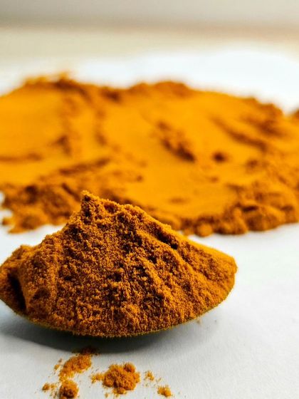 The texture and deep color of high-quality turmeric powder. Understanding ingredients is the first step to mastering a cuisine.