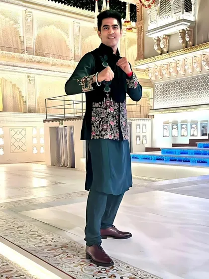 A full view of the velvet green Jawahar jacket ensemble. The tailored fit and luxurious materials create a look of regal elegance, perfect for a high-profile celebration.
