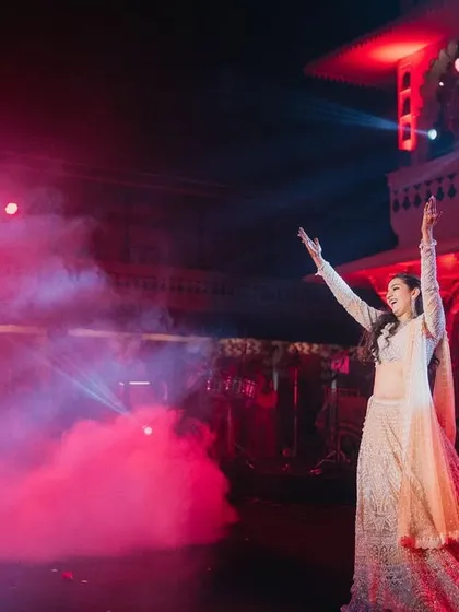 Dance is the dialogue between body and soul. This bride's expressive solo, set against a backdrop of dramatic red lighting and smoke, was a powerful and artistic performance.