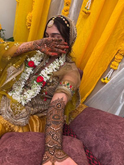 A candid shot of the bride during the ceremony, with her beautifully adorned hands.