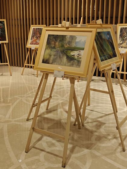 A collection of Niladri Ghosh's artworks displayed on easels at the 'Ethereal Charm' exhibition, creating a classic and elegant gallery feel.