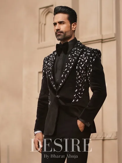 True luxury is in the details. This black velvet tuxedo features a cascade of hand-sewn silver and crystal embellishments on the lapels and shoulders, crafted for the man who appreciates timeless elegance with a modern edge.