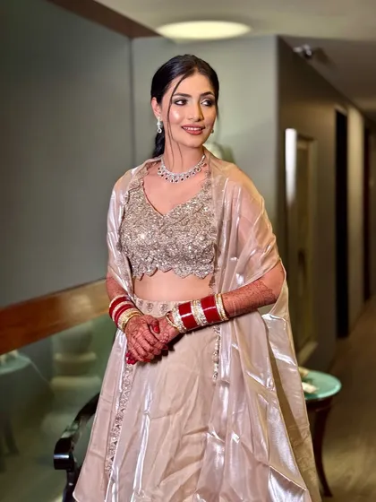 The stunning confidence of my reception bride. She is wearing a beautiful champagne-colored lehenga, and we created a soft glam look to match.