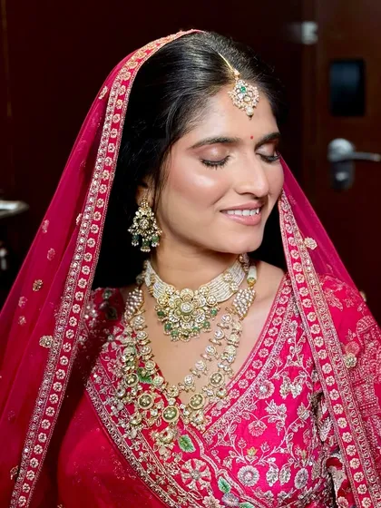 A close-up of the bride's face, showing the soft, shimmery eye makeup and the perfectly applied base.