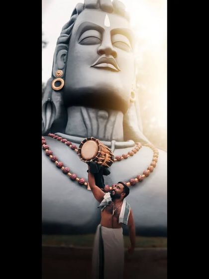 A powerful image of an artist with his Chenda before the Adiyogi statue, symbolizing our deep connection to Lord Shiva, our namesake Mahadeva.
