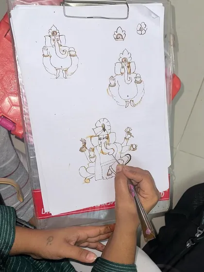 A student practicing how to draw Lord Ganesha. We cover mythological figures in our course, which are a popular request for auspicious occasions.